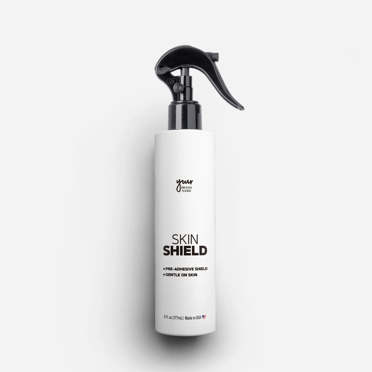 Private Label Skin Shield Spray featuring a protective barrier for secure adhesion and gentle formula in a 6 oz (177 mL) trigger spray bottle, professional wig and hair replacement preparation, made in USA
